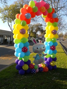 rainbow balloon arch with balloon bunny inside