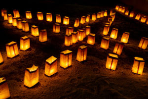 led candles in paper bags outdoors