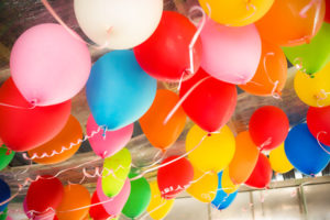Colorful balloons floating on the ceiling of a party
