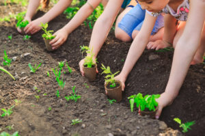 children planting garden earth day