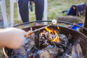 roasting-smores-over-firepit-while-backyard-camping-