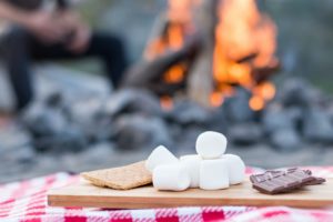 smores-supplies-on-table-in-front-of-fire
