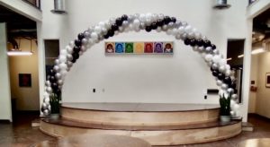 black white silver balloon arch over stage