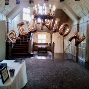 reunion spelled out in gold balloon letters