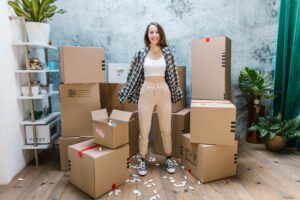 woman standing with moving boxes